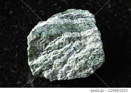 sample of raw chrysotile serpentine rock on black 129481832