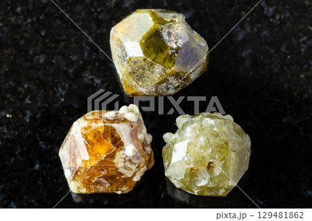 sample of three grossular garnet crystals on black sample of three grossular garnet crystals on black 129481862