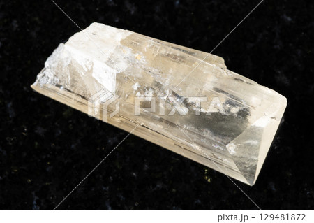 sample of rough danburite mineral on black granite sample of rough danburite mineral on black granite 129481872