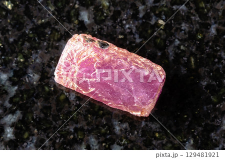 sample of raw pink ruby crystal on black granite sample of raw pink ruby crystal on black granite 129481921