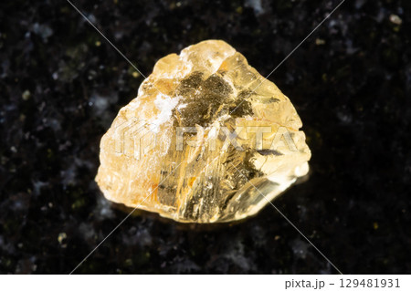 sample of rough yellow scapolite crystal on black sample of rough yellow scapolite crystal on black 129481931