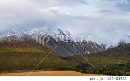 Beautiful mountain view during auto trip in Iceland. Spectacular Icelandic landscape with scenic nature: mountains, fields, clouds, glaciers, rocks. Beautiful mountain view during auto trip in Iceland. Spectacular Icelandic landscape with scenic nature: mountains, fields, clouds, glaciers, rocks. 129483482