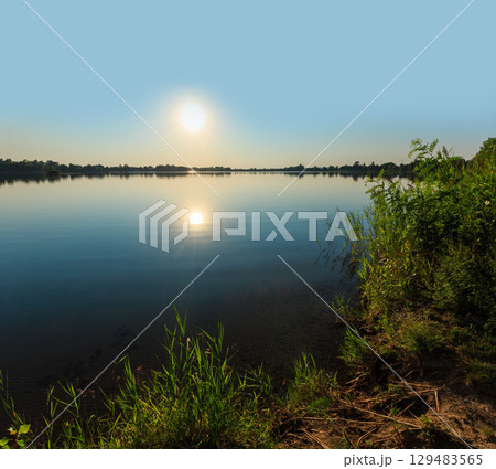 Summer sunset lake calm beach 129483565