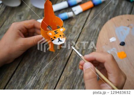 DIY and kid's creativity. Step by step instruction: how to make tiger from toilet roll tube. Step five: draw the tiger's face. 129483632
