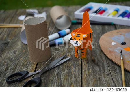 DIY and kid's creativity. Step by step instruction: how to make tiger from toilet roll tube. Ready-made craft. 129483636