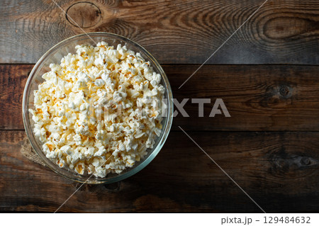 Pop corn on wood color background.Food and snack concepts ideas.Minimal style top view mockup Pop corn on wood color background.Food and snack concepts ideas.Minimal style top view mockup 129484632