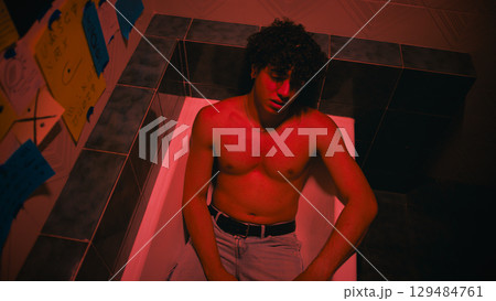 Angry And Sad Man Taking Off His Shirt Angry And Sad Man Taking Off His Shirt 129484761