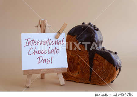 International Chocolate day saying caption on greeting card Delightful heartshaped pastry croissant treat, beautifully topped with colorful frosting galore. Copy space. Food experimentation viral International Chocolate day saying caption on greeting card Delightful heartshaped pastry croissant treat, beautifully topped with colorful frosting galore. Copy space. Food experimentation viral 129484796