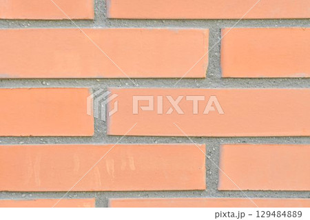 View of brick foundation. Brick wall. Brick base. Brick background. Macro image, close-up. Concept of construction and building. View of brick foundation. Brick wall. Brick base. Brick background. Macro image, close-up. Concept of construction and building. 129484889