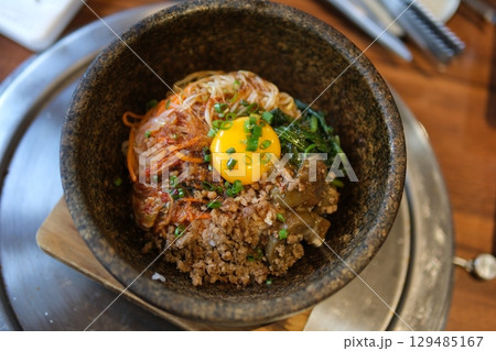 Egg rice beef close-up of a fried egg yolk drizzling over rice, accompanied by steak and sauce. Egg rice beef close-up of a fried egg yolk drizzling over rice, accompanied by steak and sauce. 129485167