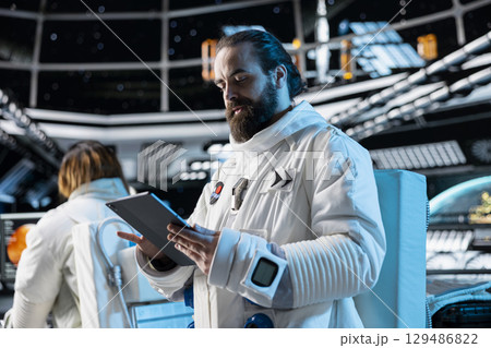 Cosmonaut tracking star and asteroids patterns, preparing for planetary mission outside. Astronaut looking at galaxy visualization, beginning landing procedures on solar system planet 129486822