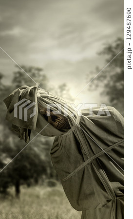 Pocong on the field at night. A traditional ghost from Indonesia that takes the form of a human wrapped in a shroud or winding sheet. Concept of Halloween 129487690