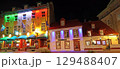Tourists enjoying walking in Old Quebec City streets, including colourful illuminated restaurants 129488407