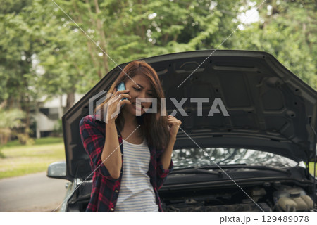 Women fix car call for help use phone calling insurance agent help fixing car problem breakdown. Woman calling mechanic car service technician support fix repair driving. Vehicle emergency problem 129489078