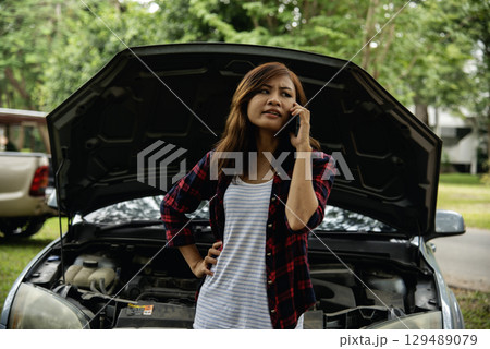 Women fix car call for help use phone calling insurance agent help fixing car problem breakdown. Woman calling mechanic car service technician support fix repair driving. Vehicle emergency problem 129489079