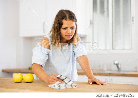 Woman housewife cleaning furniture at home kitchen Woman housewife cleaning furniture at home kitchen 129489253