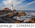 Portland Head Light in late afternoon surrounded by with dramatic waves and cliffs, Maine, USA 129489420