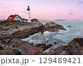 Portland Head Light at sunset surrounded by with dramatic waves and cliffs, Maine, USA 129489421