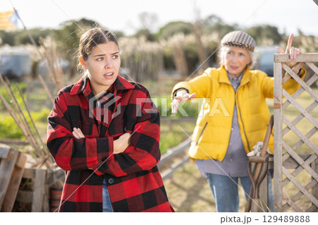 Farm neighbors quarrel over farm backyard in day Farm neighbors quarrel over farm backyard in day 129489888
