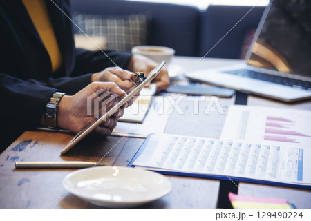 Two businesspeople meeting work at office desk. Teamwork partners team with Business strategy chart graph, infographic data financial report. Team partner planning marketing finance excel stat report 129490224