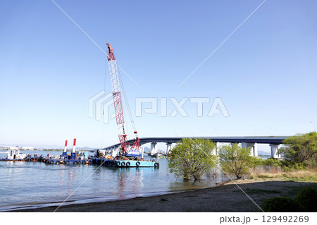 快晴の空の下b琵琶湖大橋と作業する起重機船 129492269