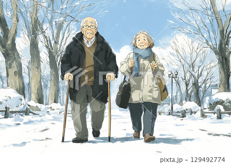 冬の公園で杖を使いながら屋外散歩を楽しむ高齢夫婦、優しい雪景色とあたたかい雰囲気、活動的で健康的 129492774