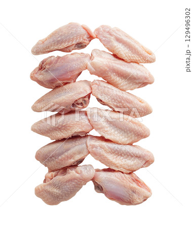 Raw chicken wings arranged in neat stack on transparency background 129496302