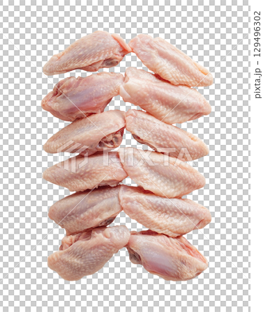 Raw chicken wings arranged in neat stack on transparency background 129496302