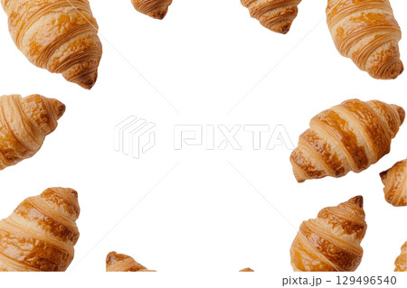 Golden croissants arranged in circular pattern on transparency background 129496540