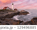 Portland Head Light at sunset surrounded by with dramatic waves and cliffs, Maine, USA 129496885