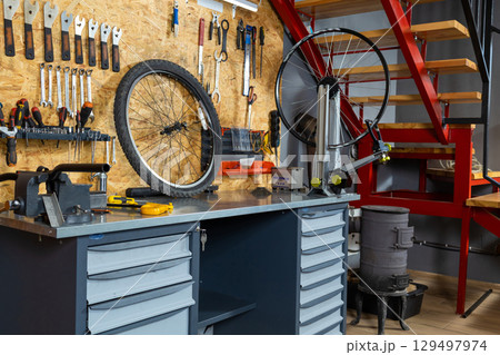 Wall organizer with wrenches, screwdrivers and pliers, bicycle wheel 129497974