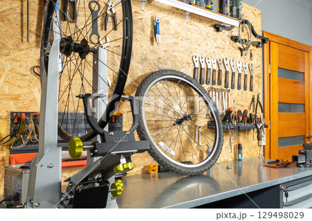 Wall organizer with wrenches, screwdrivers and pliers, bicycle wheel 129498029