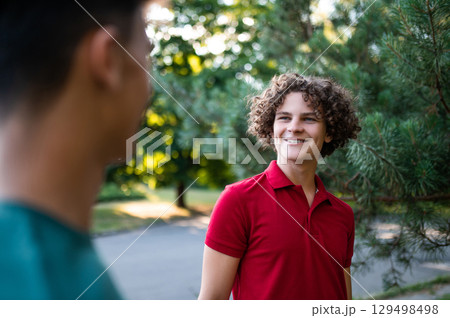 Friends spending time together in the park and looking joyful 129498498