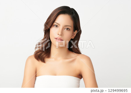 A beautiful young Asian woman with clean, fresh skin against a white background. Skincare, facial treatment, cosmetology, beauty, and spa. An elegant portrait of an Asian woman. A beautiful young Asian woman with clean, fresh skin against a white background. Skincare, facial treatment, cosmetology, beauty, and spa. An elegant portrait of an Asian woman. 129499695