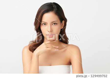 A beautiful young Asian woman with clean, fresh skin against a white background. Skincare, facial treatment, cosmetology, beauty, and spa. An elegant portrait of an Asian woman. A beautiful young Asian woman with clean, fresh skin against a white background. Skincare, facial treatment, cosmetology, beauty, and spa. An elegant portrait of an Asian woman. 129499702