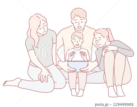 A Family Having Fun and Enjoying Quality Time Together While Engaging with a Tablet 129499988
