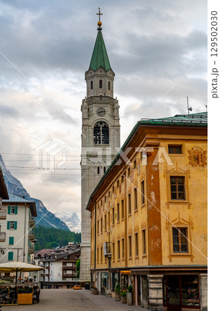 A view of the iconic church tower in the heart of Cortina d'Ampezzo. The architectural beauty of the tower stands tall against the backdrop of the surrounding Alpine scenery A view of the iconic church tower in the heart of Cortina d'Ampezzo. The architectural beauty of the tower stands tall against the backdrop of the surrounding Alpine scenery 129502030