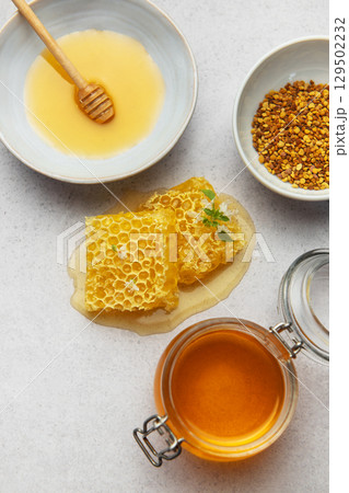Composition of honey, honeycombs and bee pollen creating delicious golden spread 129502232