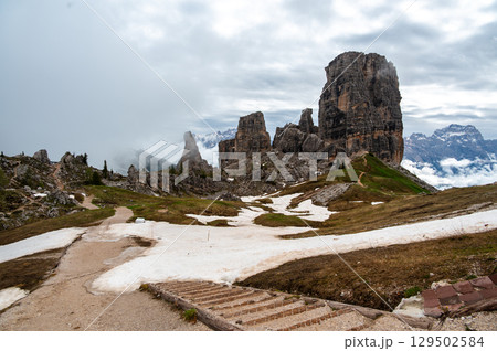 Cinque Torri rock formations in the Dolomites (Dolomiti, Dolomiten), Italy. Majestic stone towers rising above the snowy alpine landscape, a famous spot for climbers and hikers Cinque Torri rock formations in the Dolomites (Dolomiti, Dolomiten), Italy. Majestic stone towers rising above the snowy alpine landscape, a famous spot for climbers and hikers 129502584