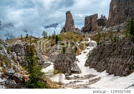 Cinque Torri rock formations in the Dolomites (Dolomiti, Dolomiten), Italy. Majestic stone towers rising above the snowy alpine landscape, a famous spot for climbers and hikers Cinque Torri rock formations in the Dolomites (Dolomiti, Dolomiten), Italy. Majestic stone towers rising above the snowy alpine landscape, a famous spot for climbers and hikers 129502598