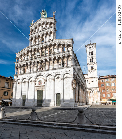Panoramic view of Chiesa di San Michele in Foro in the historic center of Lucca Italy on a sunny summer day with clear blue sky and warm light on the ancient architecture 129502705