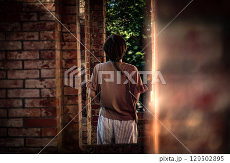 ＜素材＞夕暮れ観光地で風景写真を撮る女性 129502895