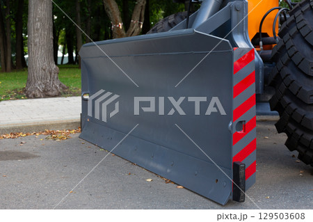 Attachments for road cleaning. Plow blade in front of special equipment for clearing roads from mud and snow. Development of city streets using special equipment for tractors Attachments for road cleaning. Plow blade in front of special equipment for clearing roads from mud and snow. Development of city streets using special equipment for tractors 129503608