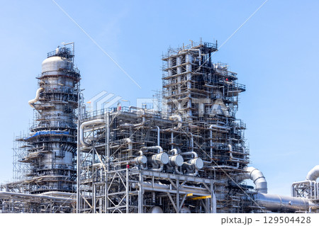 Oil and Gas refinery petrochemical plant industrial on blue sky background, Oil and Gas refinery petrochemical plant pipeline steel, Oil and Gas refinery factory maintenance, Global energy refinery. 129504428