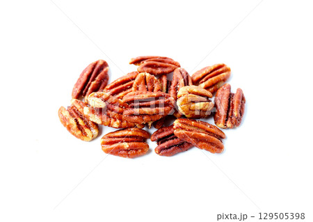 Delicious salted pecan nuts scattered. Delicious salted pecan nuts scattered. 129505398