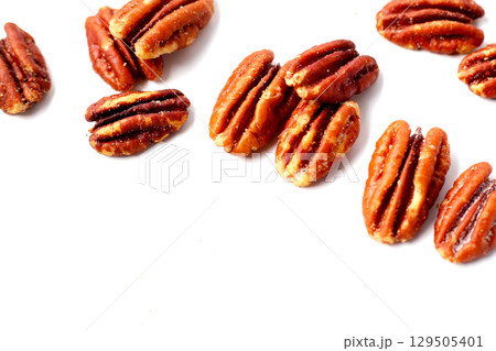 Delicious salted pecan nuts scattered. Delicious salted pecan nuts scattered. 129505401