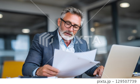 insurance specialist reviewing documents with client remotely 129507739