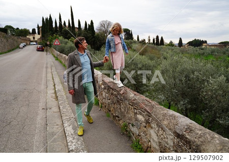 Father and Daughter Walking on Old Stone Wall 129507902