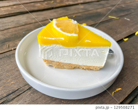 Slice of Lemon Cheesecake on White Plate 129508271