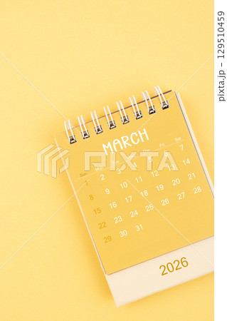 March 2026 Yellow desktop calendar on a yellow color background. 129510459